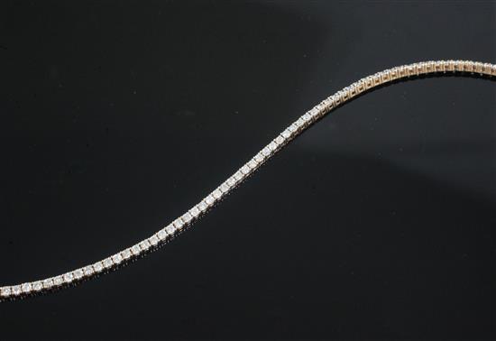 An 18ct rose gold and diamond set line bracelet, 17.5cm.